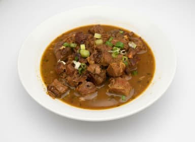 Curry goat with roti at Bamboo Fire Cafe in Delray Beach